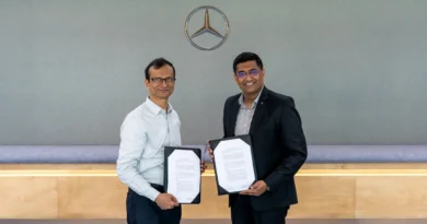 Representatives from Mercedes‑Benz Research and Development India and IIT Delhi exchanging documents during the signing of a five‑year research collaboration agreement