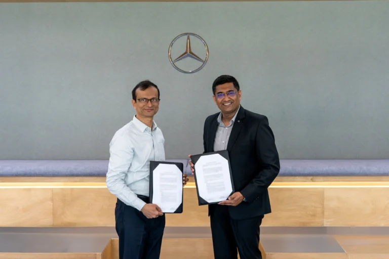 Representatives from Mercedes‑Benz Research and Development India and IIT Delhi exchanging documents during the signing of a five‑year research collaboration agreement