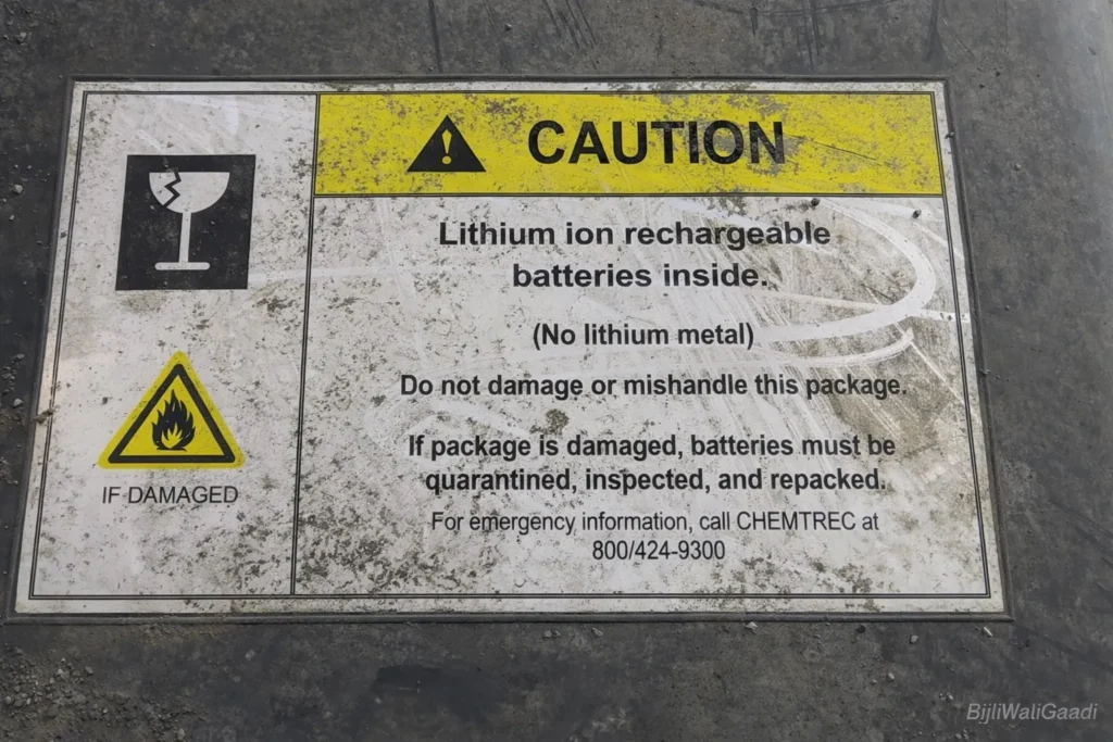 EV Battery Replacement Cost in India - Close-up of lithium-ion battery caution label showing safety instructions and hazard symbols on EV battery packaging