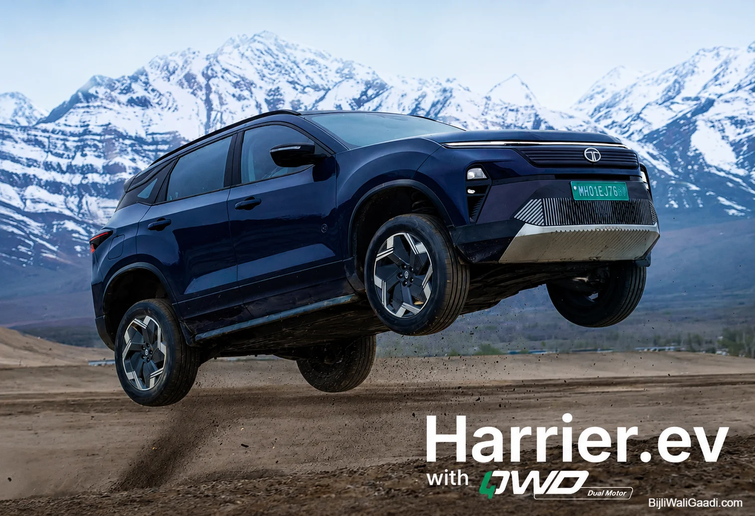 Tata Harrier EV AWD electric SUV performing an off-road jump with snow-capped mountains in the background, showcasing dual-motor all-wheel-drive capability in India.