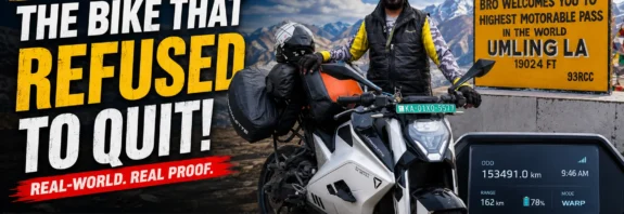 Ultraviolette F77 electric motorcycle with 153491 km odometer reading at Umling La mountain pass featuring rider and long-term ownership milestone.
